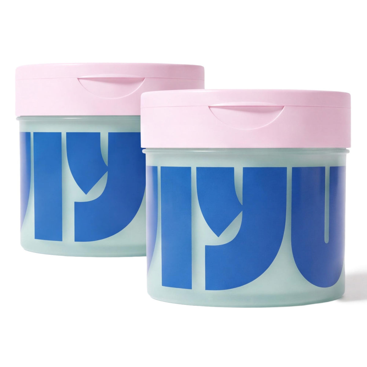Two mint-green jars of face pads with pink flip lids, one slightly behind the other