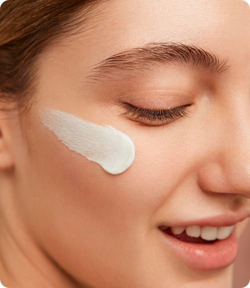 Model with cream swipe on cheek