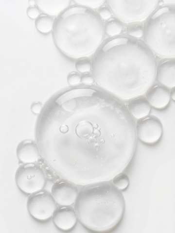 Clear gel bubbles of varying sizes clustered on a white surface